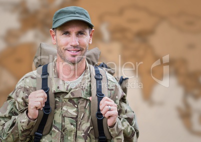 Soldier with backpack against blurry brown map