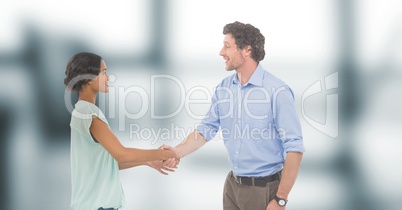 Business people shaking hands against blurred background