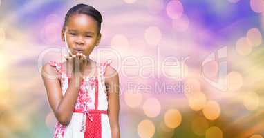 Little girl giving flying kiss over blur background