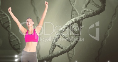 Healthy woman with hands raised against DNA structures