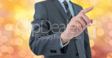 Midsection of businessman using imaginary screen over bokeh