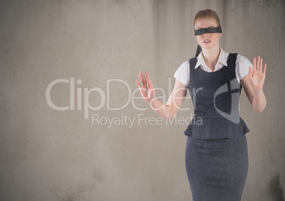 Business woman blindfolded with grunge overlay against brown background