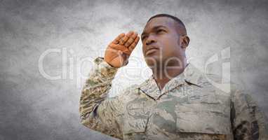 Soldier saluting against white wall with grunge overlay