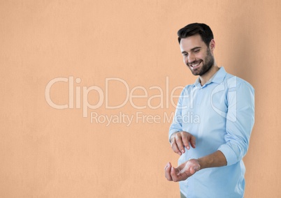 Happy businessman gesturing against orange background