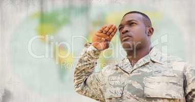 Soldier saluting against blurry map with grunge overlay