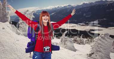 Happy woman traveling on snow covered mountains