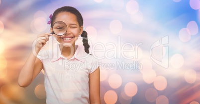 Girl looking through magnifying glass