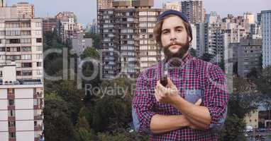 Hipster holding smoking pipe in city