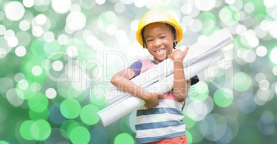 Happy girl holding blueprints against bokeh