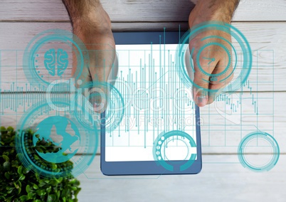 Hands using digital tablet on wooden table