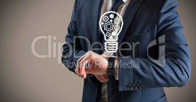 Business man mid section with lightbulb doodles over watch against brown background