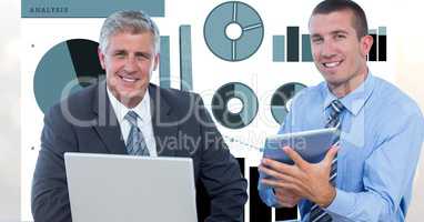 Confident businessmen with technologies and graphs