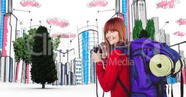 Digitally generated image of female tourist holding camera with buildings and trees in background