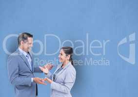Happy business people talking against blue background