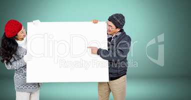 Couple holding blank billboard against green background