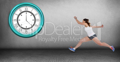 Fit woman running late with clock mounted on wall