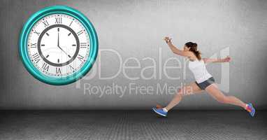 Fit woman running late with clock mounted on wall