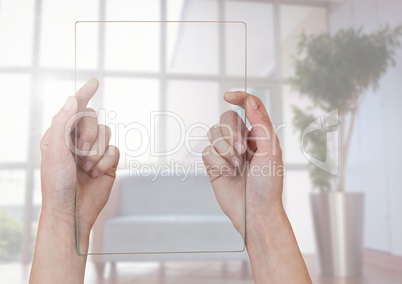 Hands holding glass screen against window