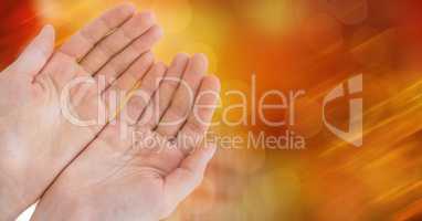 High angle view of cupped hands against glowing bokeh