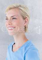 Close up portrait of woman smiling against grey wall
