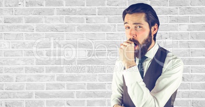 Hipster coughing against wall
