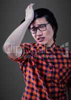 Stressed man against grey wall