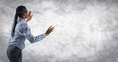 Back of business man blindfolded with grunge overlay against white wall