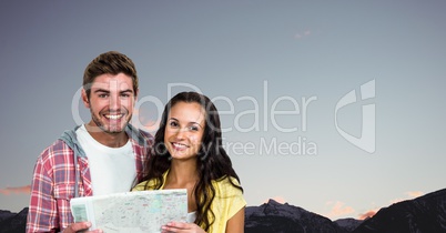 Portrait of happy couple holding map against clear sky