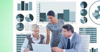 Business people discussing while using laptop against graphs