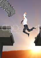 businessman jumping to catch the checker flag