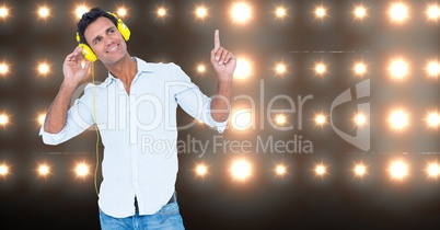 Man pointing while listening to music on headphones
