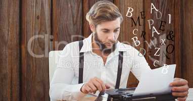 Hipster using typewriter against wall