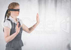 Business woman blindfolded with grunge overlay against white wall