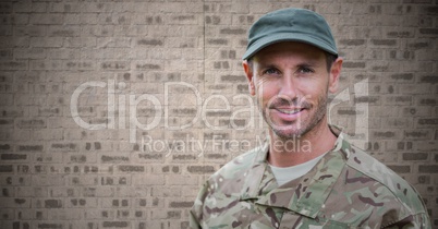 Soldier against brown brick wall