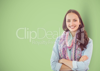 Casual businesswoman with arms crossed over green background