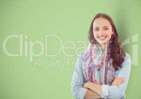 Casual businesswoman with arms crossed over green background