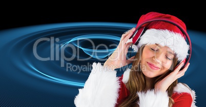 Woman in Santa costume listening to music on headphones