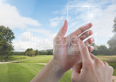 Hand Touching Glass Tablet in nature park with sky