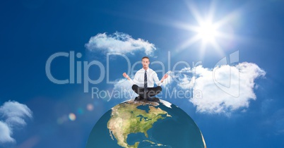 Businessman meditating on earth against sky