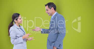 Business people talking against green background