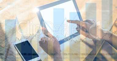 Hand touching digital tablet with graph overlay