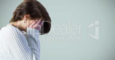 Woman profile with hands over face against light blue background