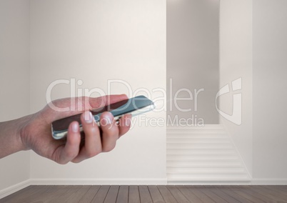 Hand holding a mobile phone and room with steps