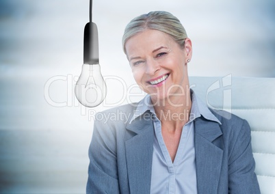 Business woman in chair with glowing lightbulb against blurry blue wood panel