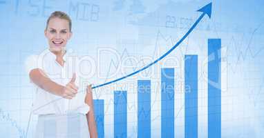 Smiling businesswoman showing thumbs up against graph