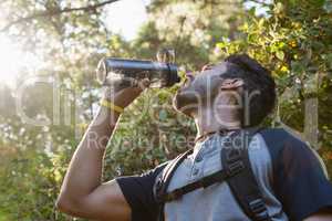 Thirsty man drinking water in the forest