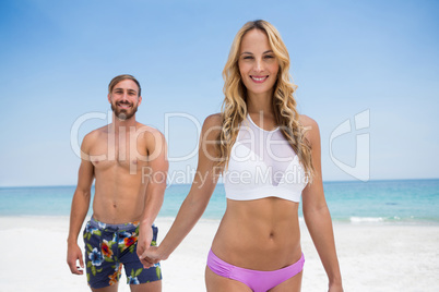 Portrait of couple walking at beach