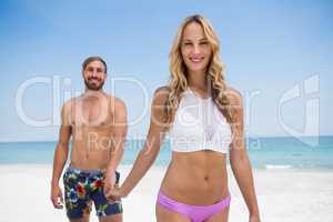 Portrait of couple walking at beach