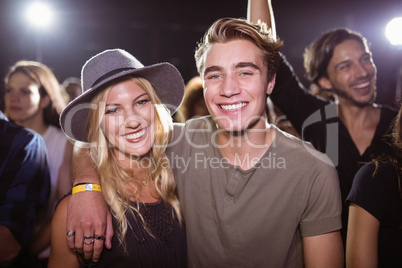 Portrait of smiling friends standing at nightclub
