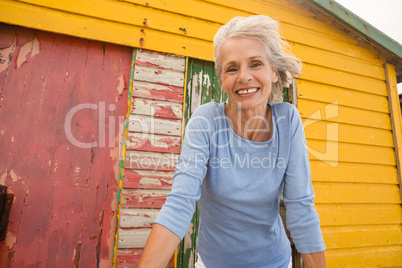 Low angle view of happy woman looking away against wall